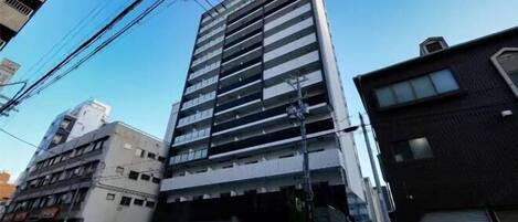 A modern building with a glass facade and multiple floors.