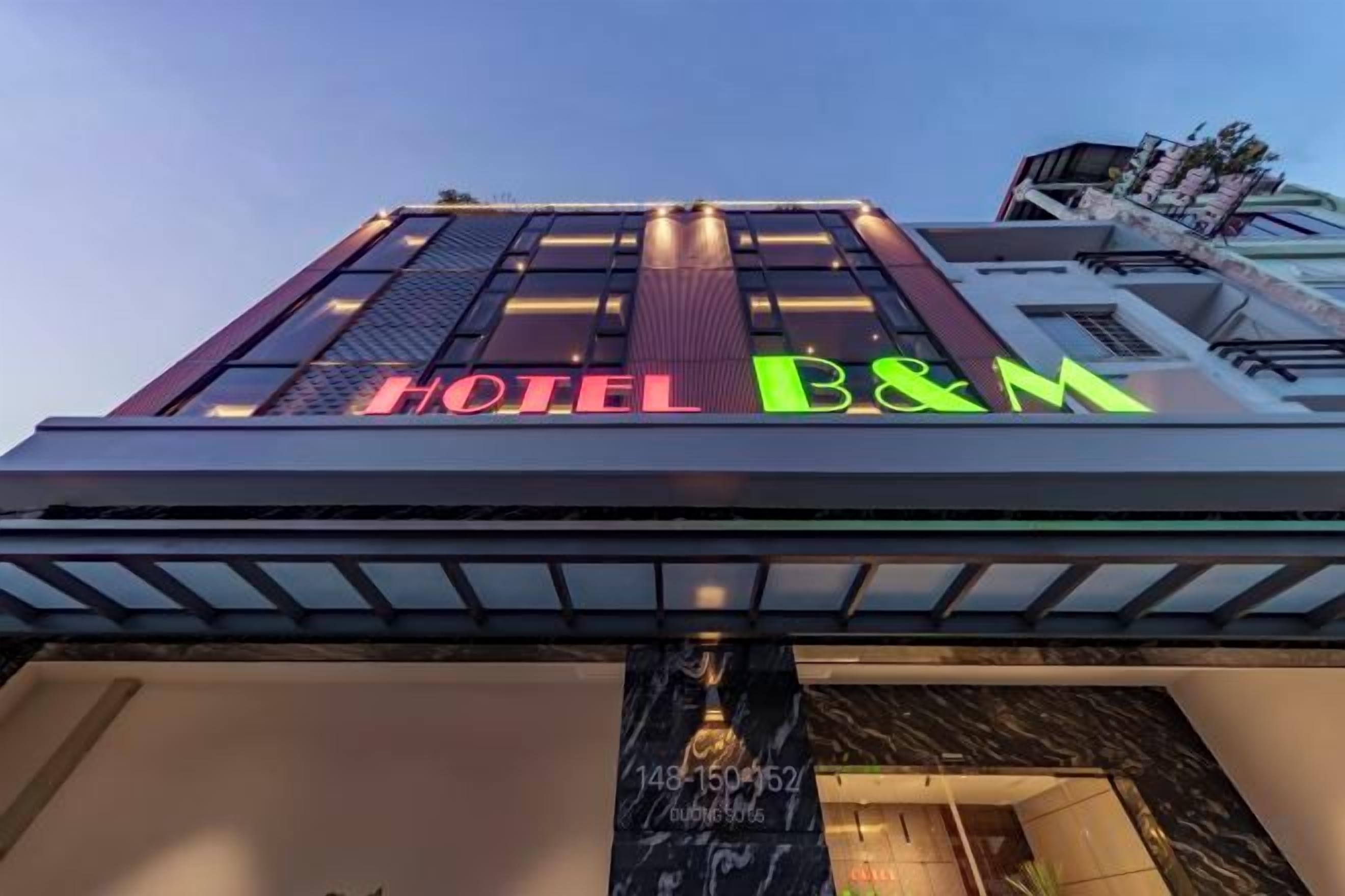 A hotel sign with the name 'HOTEL B&M' in large letters.