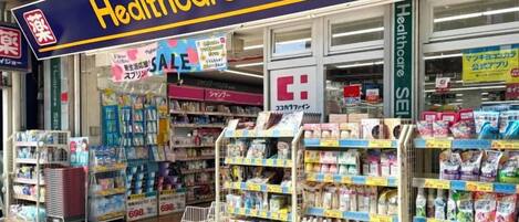 A pharmacy with a prominent 'Healthcare' sign, shelves stocked with various products, and a sale sign.