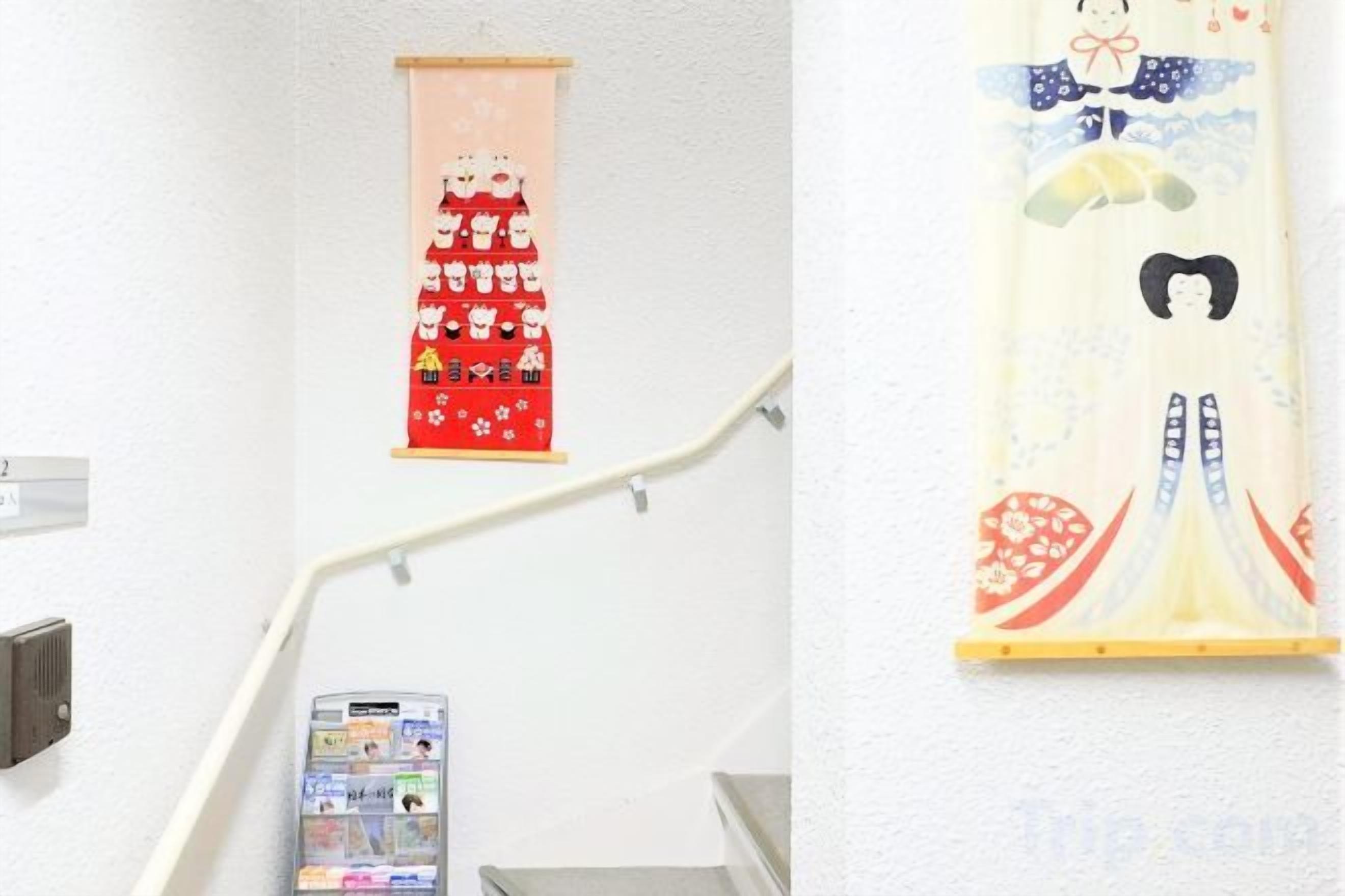A staircase with handrails and a wall-mounted phone.