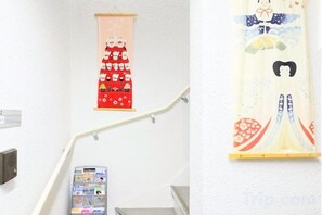 A staircase with handrails and a wall-mounted phone. - Tokyo Sakura Hotel (Tokyo)