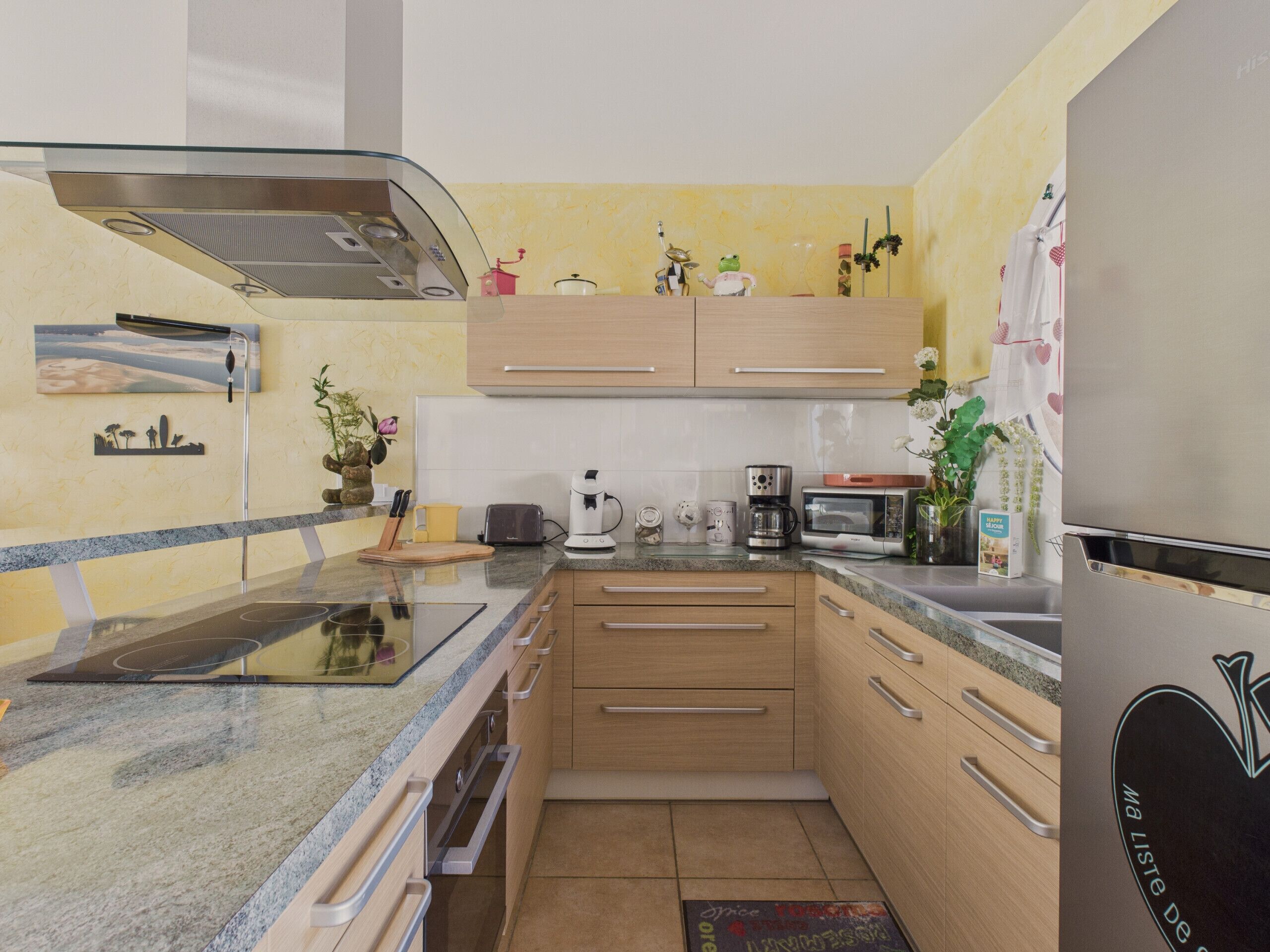 A modern kitchen with a built-in stove, microwave, and refrigerator.