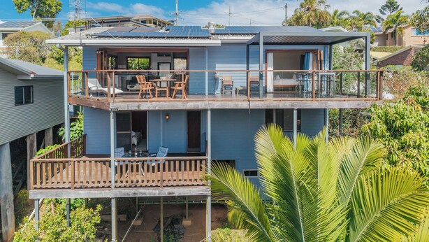 A two-story house with a balcony, solar panels, and a dining area. - Hillcrest Retreat with River Views (Tweed Heads South)