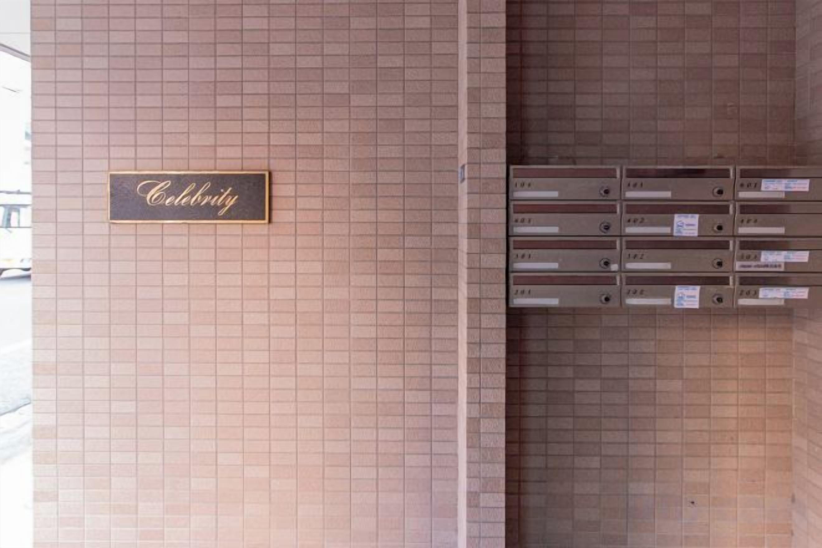 A wall with a 'Celebrity' sign and a row of mailboxes.