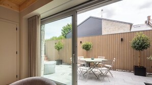 A room with a sliding glass door leading to an outdoor patio with a table and chairs. - 3 bedroom house with Jacuzzi (Hotton)
