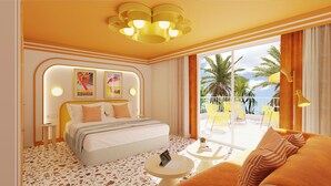A hotel room with a bed, a sofa, a small table, a balcony with yellow chairs, and a view of palm trees. - Riviera Hotel Menorca  (Ciutadella de Menorca)