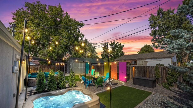 A backyard with a hot tub, string lights, and outdoor furniture. - Olde Town Gem: 5 TVs + Hot Tub & Game Yard (Arvada)