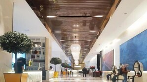 A spacious lobby with a high ceiling, modern lighting fixtures, and seating areas. - Ritz Residence Platinum KL (Kuala Lumpur)