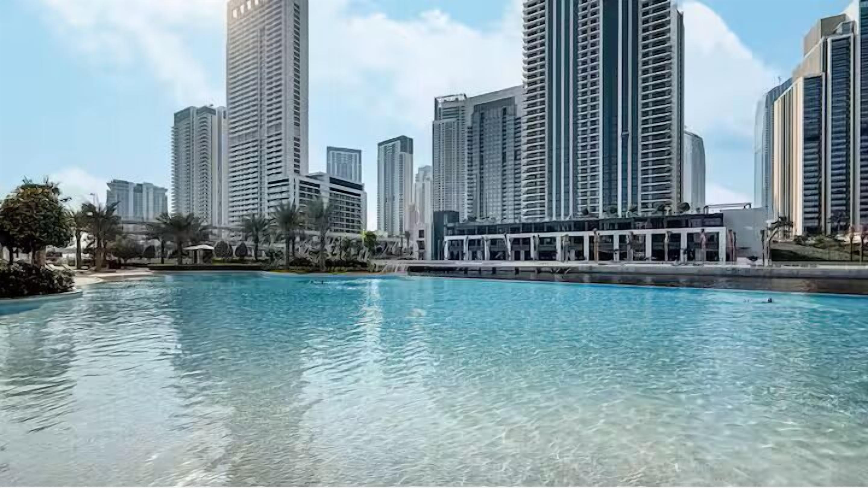 A swimming pool with high-rise buildings in the background.