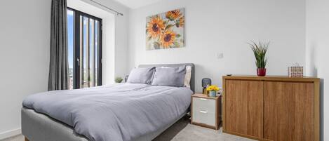 2 habitaciones, escritorio y tabla de planchar con plancha