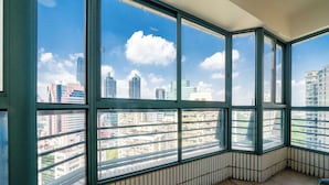 A corner room with large windows offering a cityscape view.