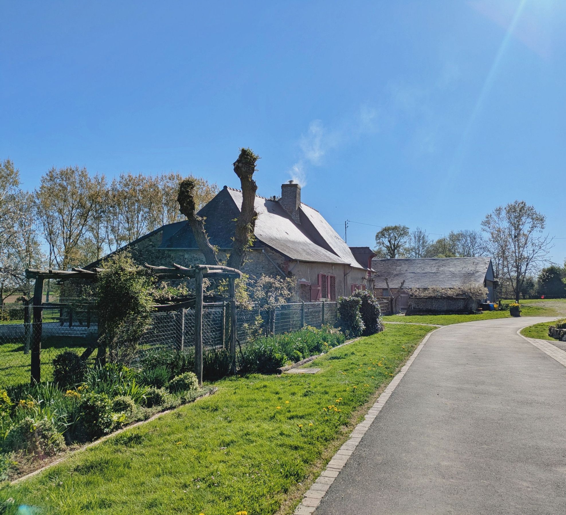 Extérieur : terrasse clôturée à l’arrière, avec vue sur la basse-cour, salon de jardin, parasol, barbecue - H53G030679 - Gîte du Hérisson, Saint-Michel-de-la-Roë – Gîtes de France Mayenne