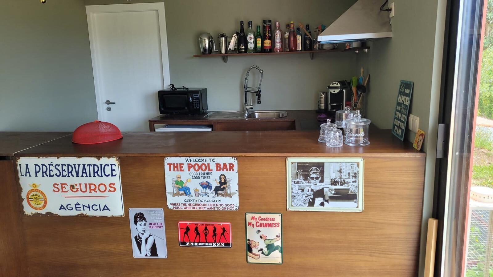 A reception desk with various signs and a coffee machine.