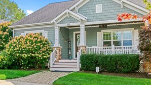 A house with a porch, a mailbox, and a number '108' on the front. - All In | Pool Access | Fire Pit | Game Room (South Haven)