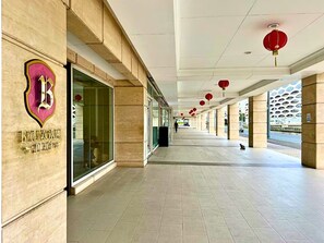 A modern building with a Balmyral logo, large glass windows, and red lanterns. - Stay Beside Mall of Asia Walk & Explore (Parañaque)