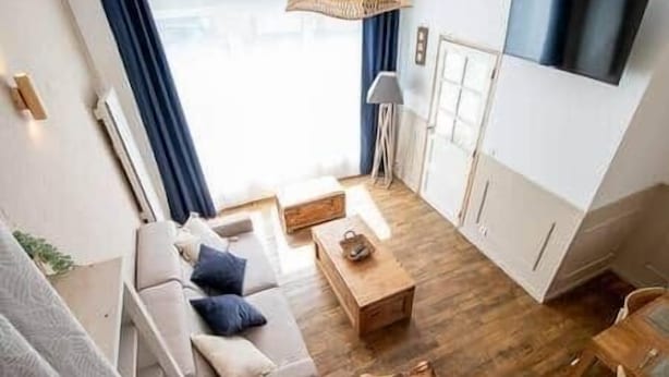 A modern living room with a sofa, coffee table, and a view of the outdoors. - Gevelled, Town house Perros (Perros-Guirec)