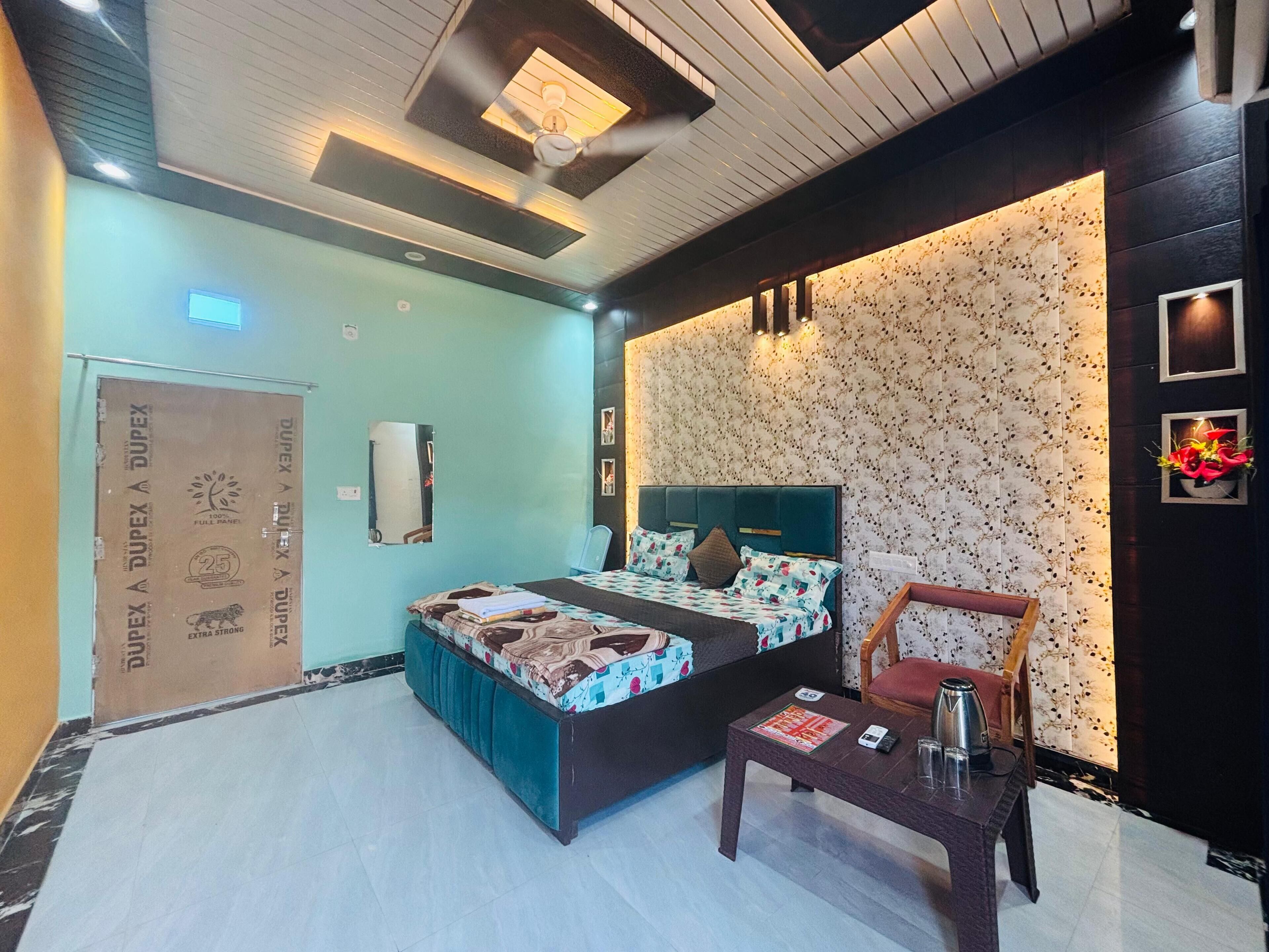A modern bedroom with a bed, a desk, and a chair.