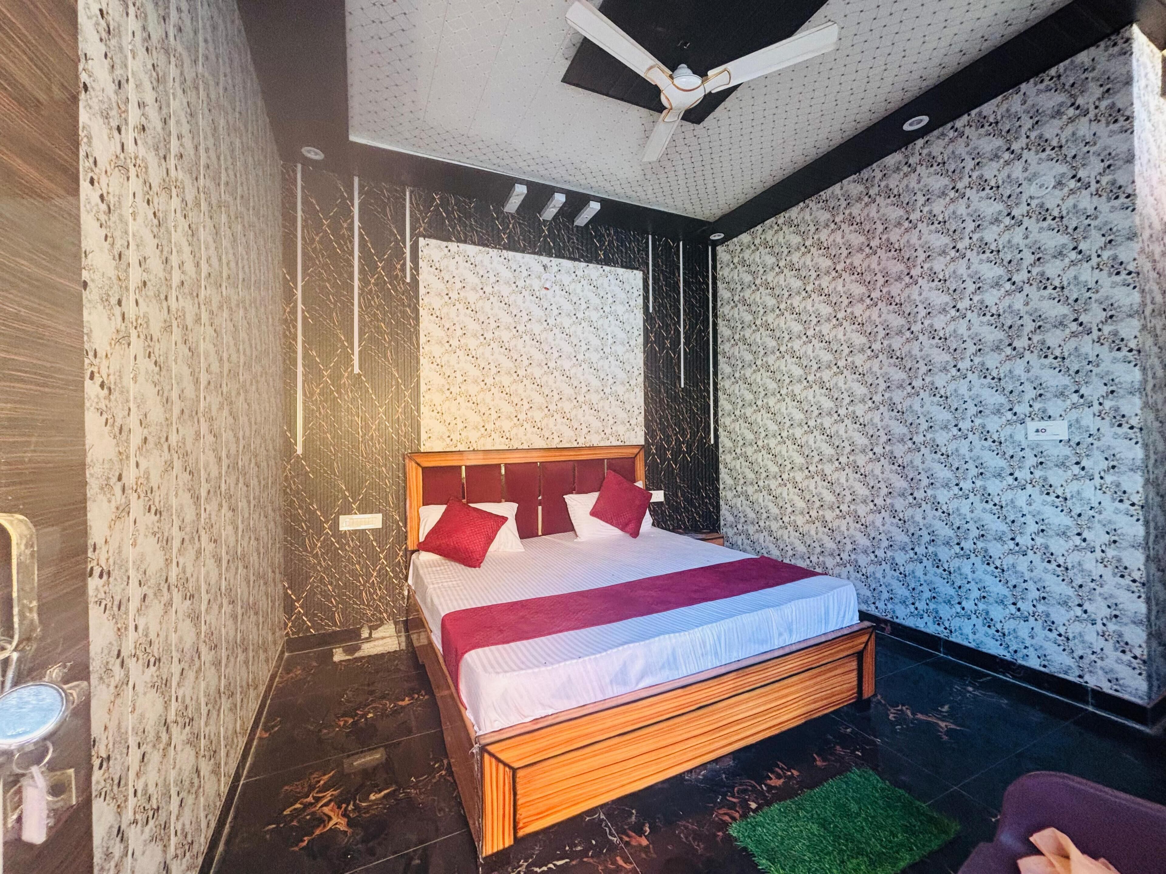 A modern bedroom with a wooden bed, patterned wallpaper, and a ceiling fan.