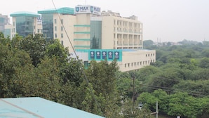 A MAX Healthcare building with multiple floors and a signboard. - Flourish Inn Saket opposite Max Hospital (New Delhi)