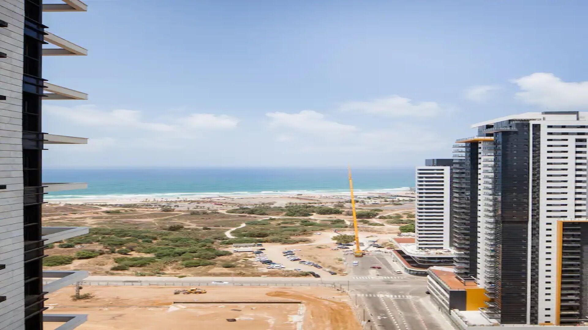 A high-rise building with a view of the beach and ocean.