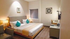 A hotel room with a bed, bedside lamps, a desk, and a chair. - The Mayberry A Bergamont Hotel Tiruppur (Tirupur)