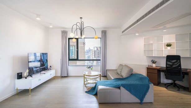 A modern living room with a television, sofa, and desk. - Tyms Elegant 4BR 2BA Apt in Xujiahui (Shanghai)