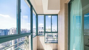 A high-rise apartment with large windows offering city views. - Tyms Elegant 4BR 2BA Apt in Xujiahui (Shanghai)