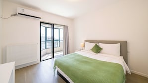 A hotel room with a bed, a radiator, a window, and a view of the city. - Tyms Elegant 4BR 2BA Apt in Xujiahui (Shanghai)