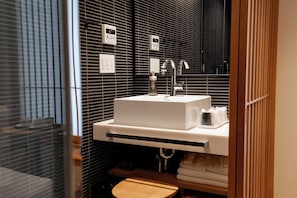 Standaard Twin kamer | Badkamer | Een haardroger, pantoffels, een bidet, handdoeken