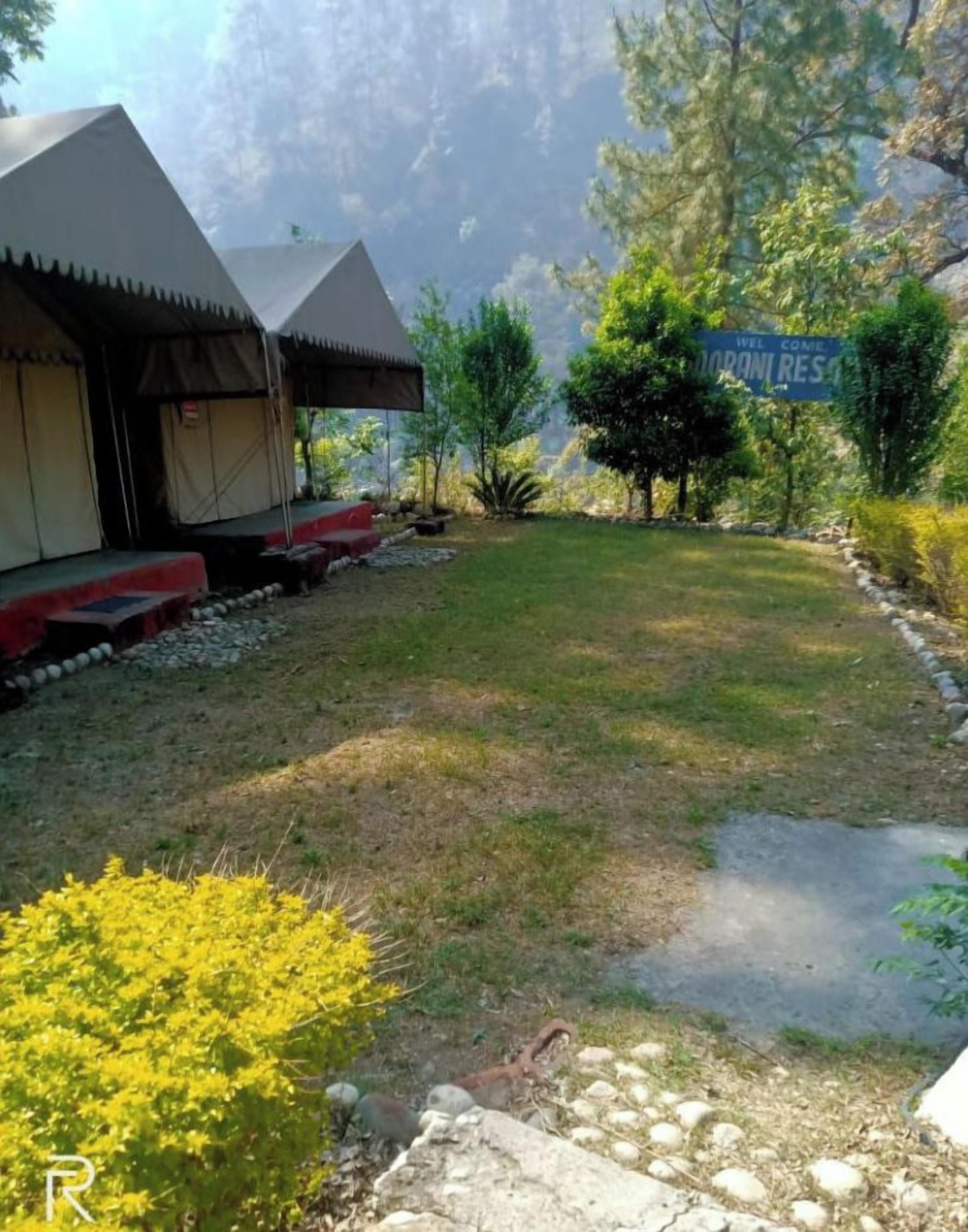 A campsite with tents and a sign welcoming visitors.