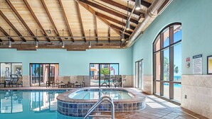 A swimming pool with a hot tub, lounge chairs, and a view of the outdoors. - 1002E-Beautiful 2 bedroom and 2 bath newly remodeled unit (Orange Beach)