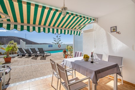 Outdoor dining. Vacation Home 'Carmelo' with Shared Pool, Wi-Fi and Air Conditioning