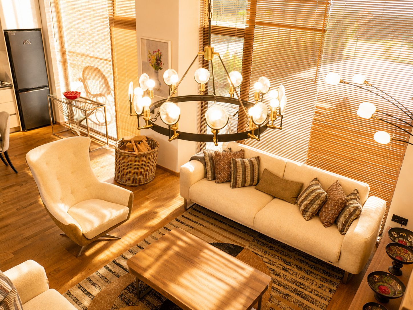 A modern living room with a sofa, armchair, and a wooden coffee table.