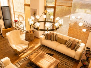 A modern living room with a sofa, armchair, and a wooden coffee table. - Matilda Signature Villas (Telavi)