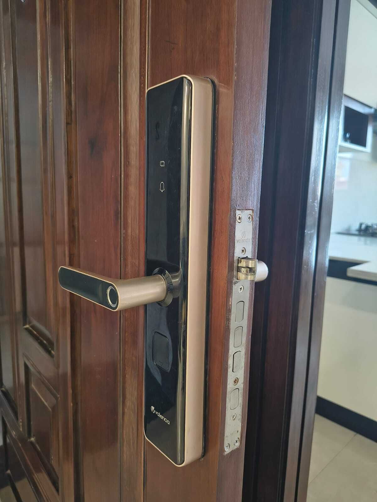A door with a modern electronic lock and a keyhole.