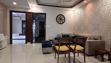 Luxury Twin Room, City View | Living area | 50-inch Smart TV with digital channels