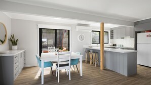 A modern kitchen with a central island, grey cabinets, and a white countertop. - OPI San Remo with water views (San Remo)