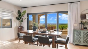 A dining area with a table and chairs, a potted plant, and a view of the landscape. - Villa Azulejos, Luxury villa with privacy and breathtaking views (Cabo San Lucas)