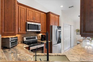 Fridge, microwave, oven, stovetop - Serene Lakefront Condo with Pool (Naples)