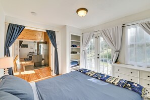 A bedroom with a bed, a wardrobe, a window with curtains, a desk, and a chair. - Ice Fish, Snowshoe & Ski: Group Getaway in Summit (Summit)