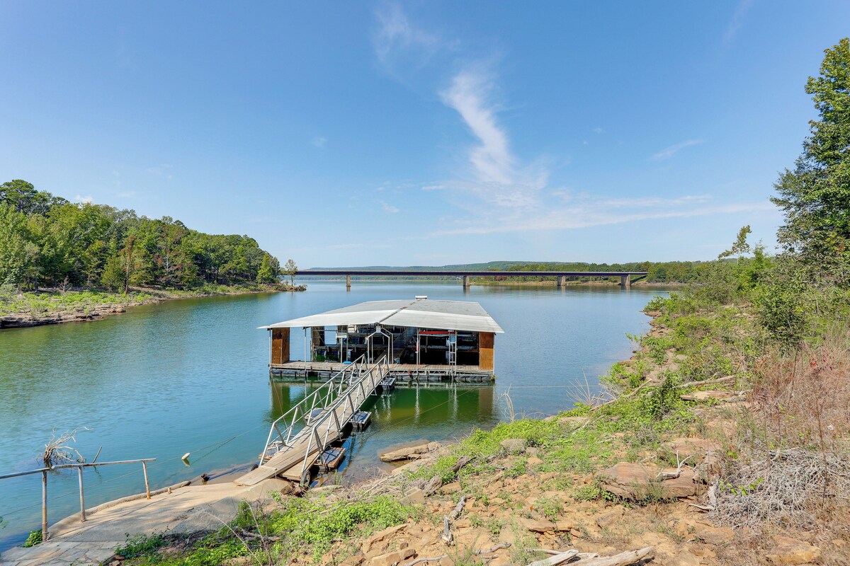 A floating structure with a covered deck and a staircase leading into the water.