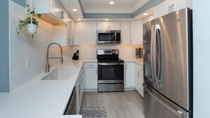 Fridge, stovetop, coffee/tea maker, cookware/dishes/utensils