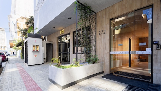 A modern building with a glass entrance, a visible address number 272, and a sign for 'SOUL'. - Apart w/ Barbecue 800m From the Beach Sre1403 (Itapema)