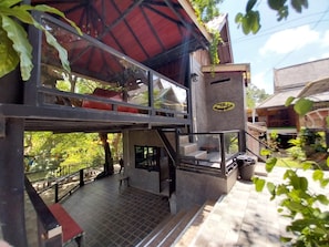 A two-story building with a red roof, a balcony, and a staircase. - Bamboo River House Kaeng Krachan (Kaeng Krachan)