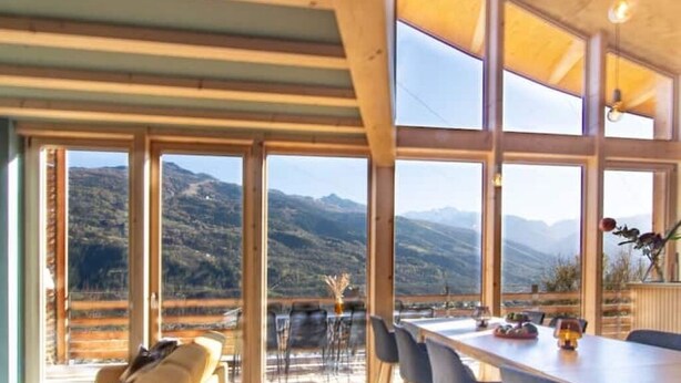 A dining area with large windows offering mountain views.