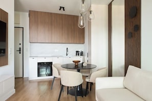 Deluxe Apartment, Balcony, River View | Living area | Flat-screen TV