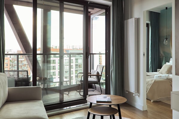 Deluxe Apartment, Balcony, River View | Living area | Flat-screen TV