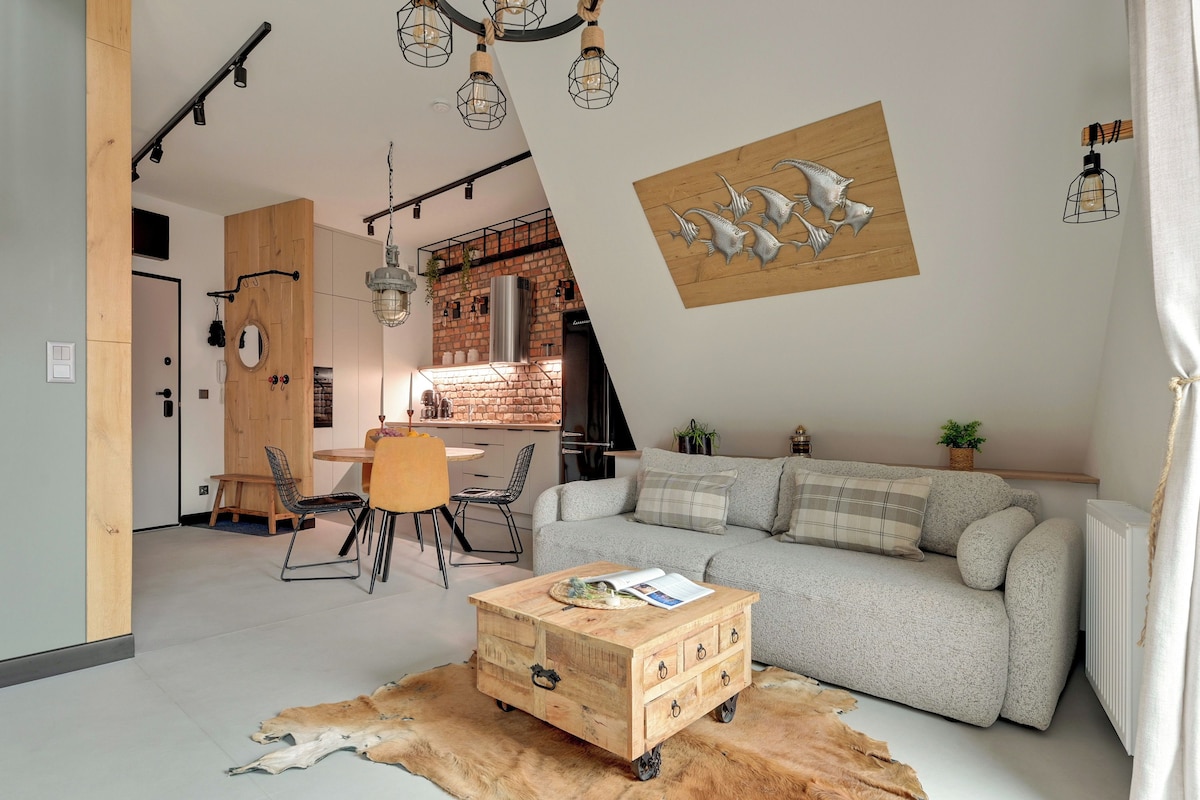 A modern living space with a dining area, a sofa, and a coffee table.
