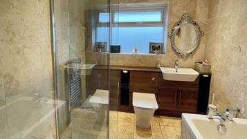 Separate bathtub and shower, deep-soaking bathtub, hair dryer, towels