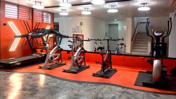 A gym with treadmills, stationary bikes, and a stair climber.